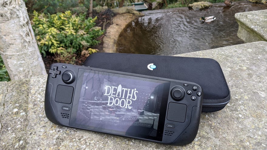 A Steam deck, on wall outdoors, running Death’s Door.