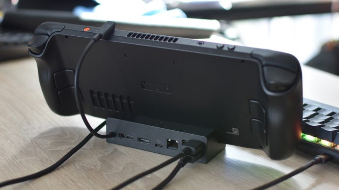 A rear view of the Valve Steam Deck Docking Station, holding a Steam Deck OLED with a mouse and keyboard connected.