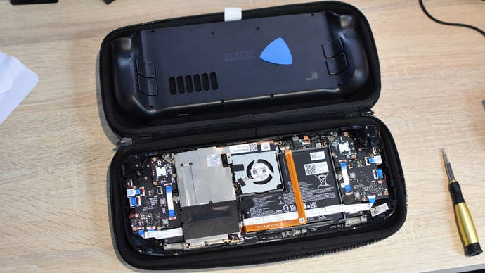 An opened Steam Deck on a desk, showing its internal components.