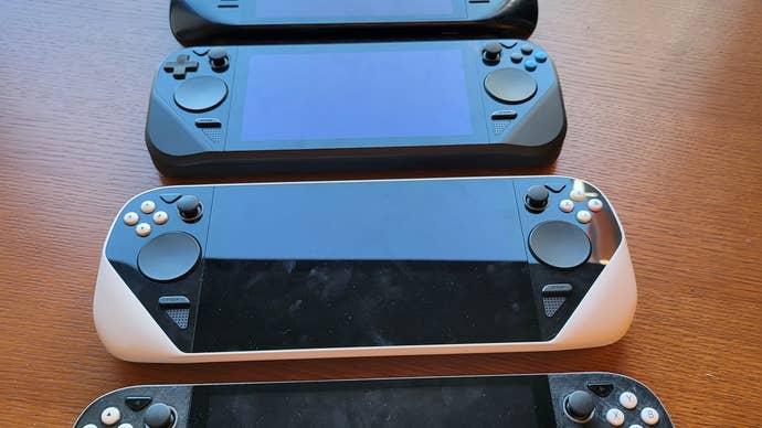 Several Steam Deck protoypes laid out on a table.