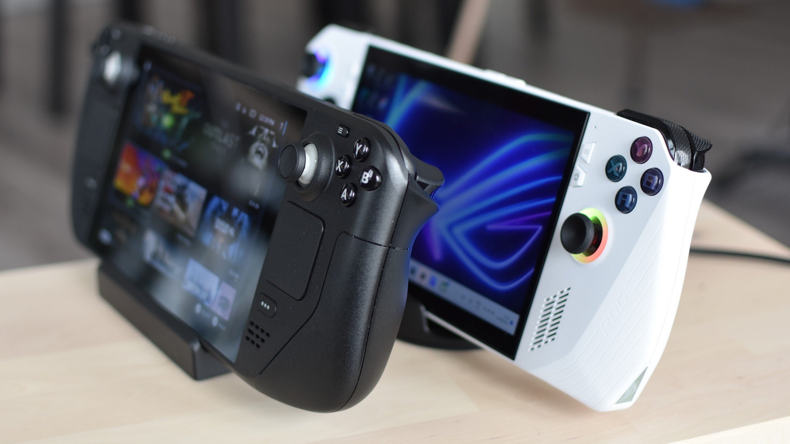 A Steam Deck and Asus ROG Ally on a table.