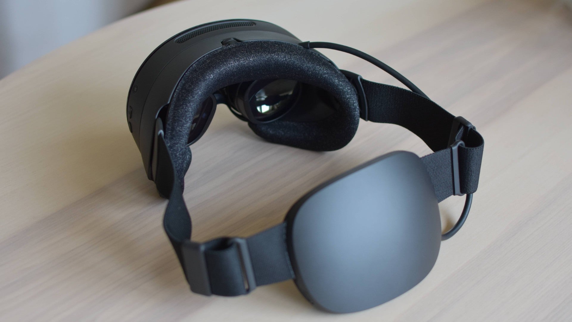 The Steam Frame VR headset on a table.
