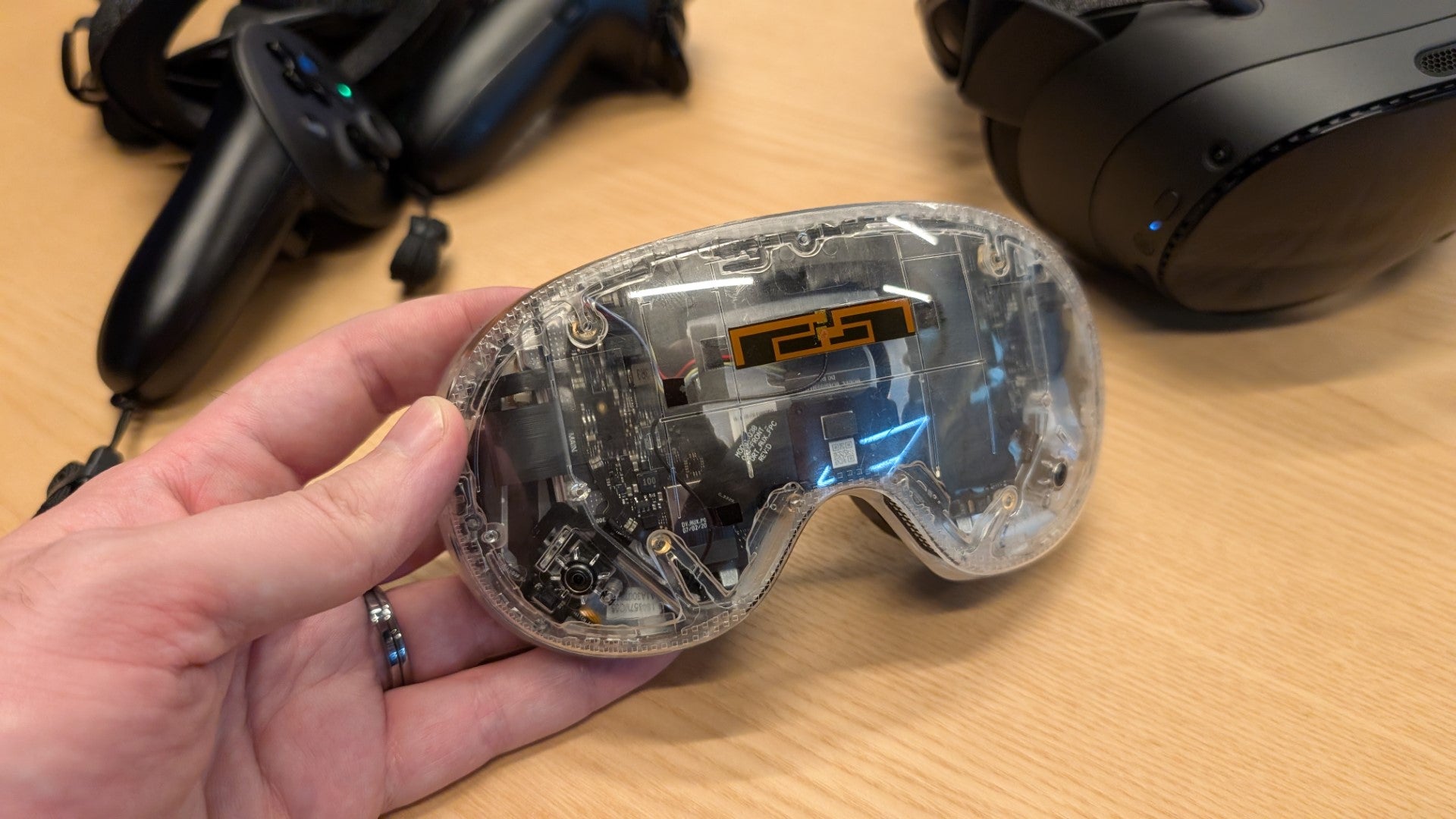 A clear-shelled modular lens unit for the Steam Frame, removed from the headset. - 4