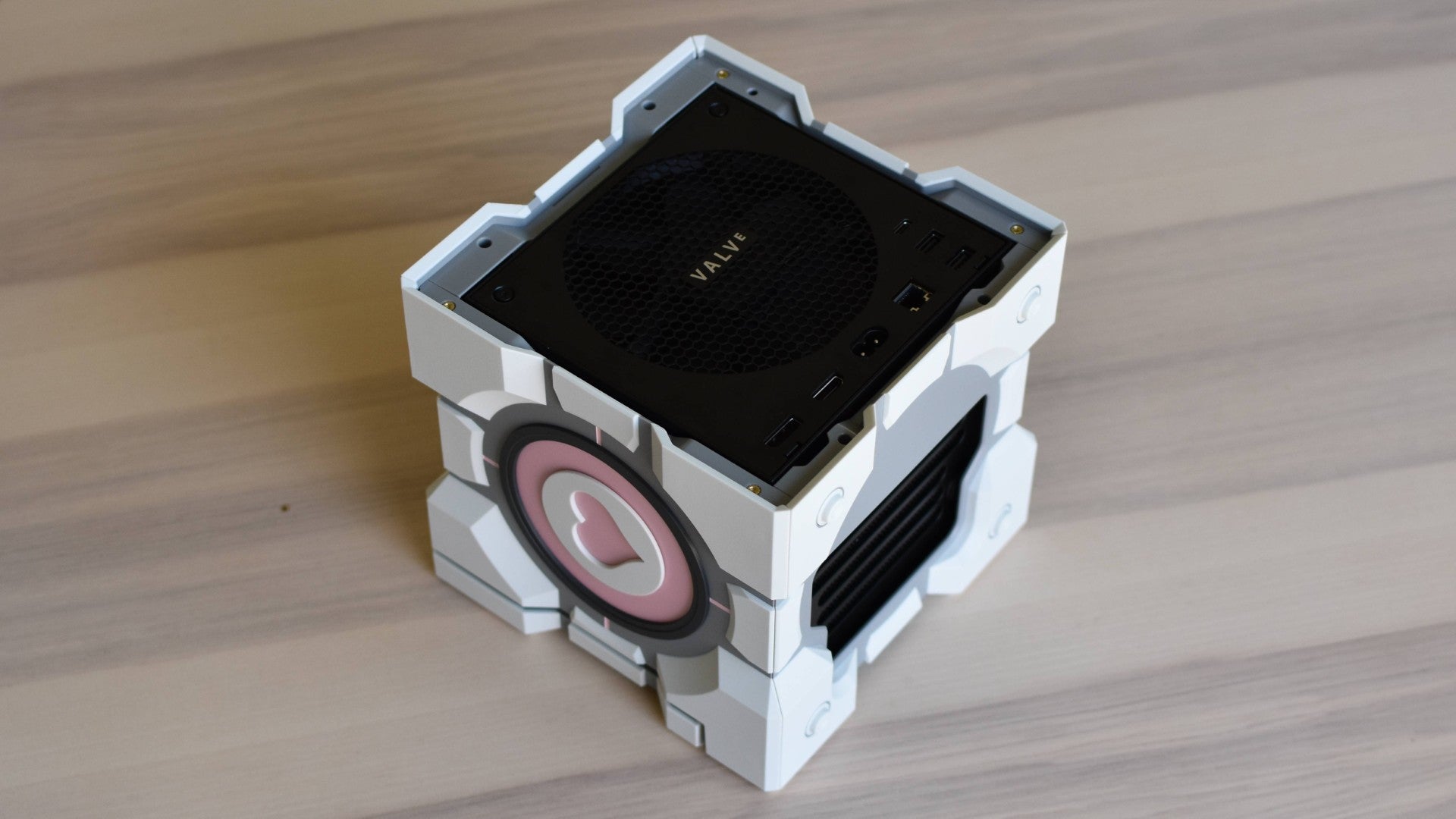 A Steam Machine partly installed in Dbrand's Companion Cube case.
