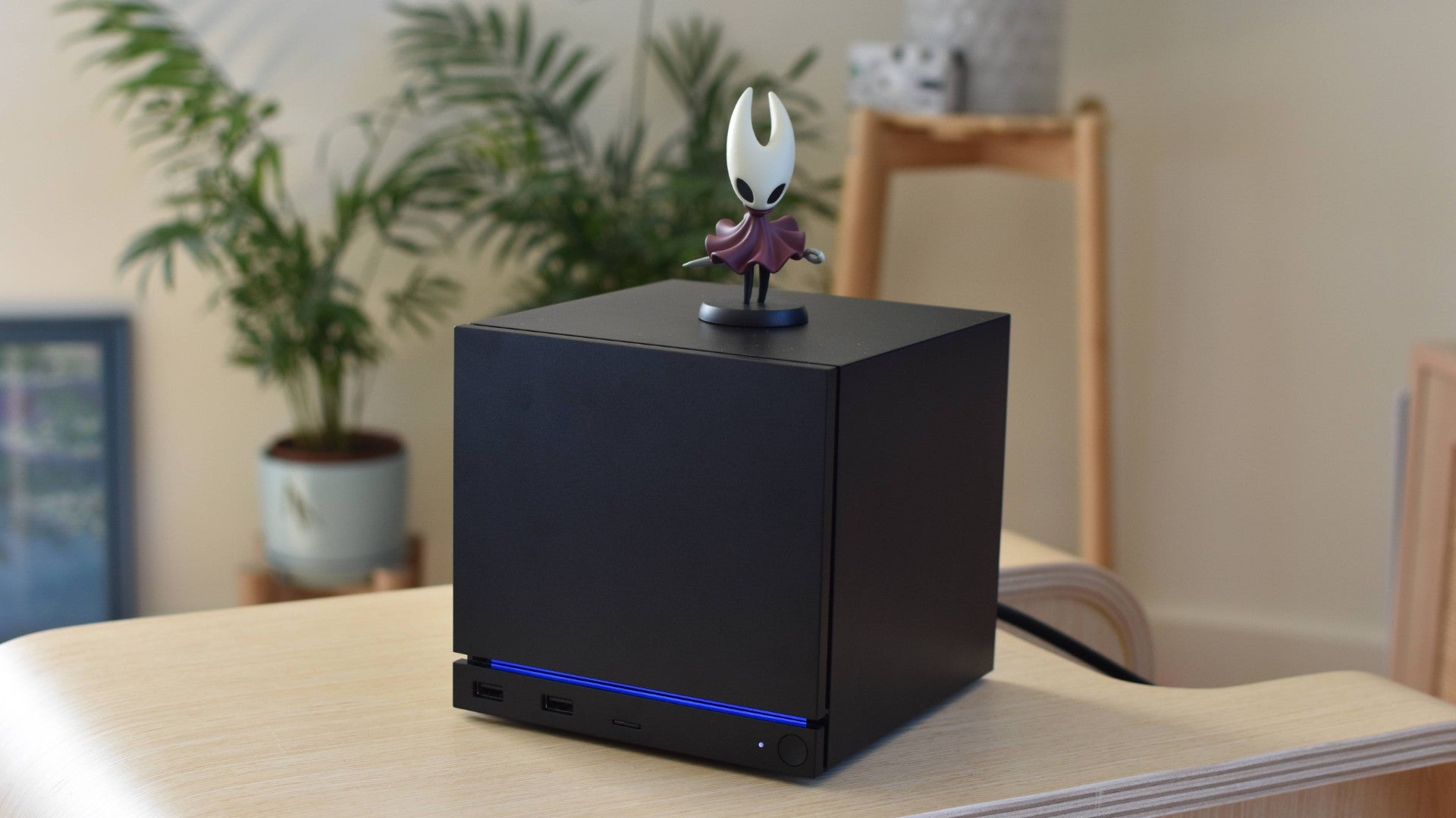 A Steam Machine with a figurine of Hollow Knight's Hornet on top of it.