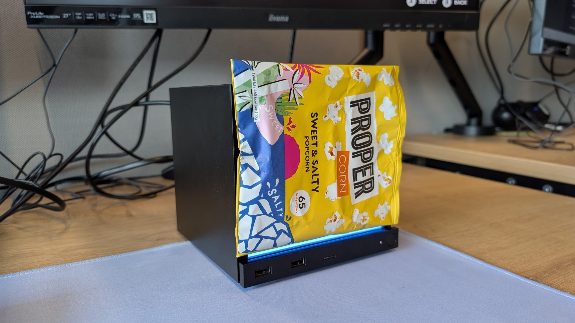A Steam Machine with an empty popcorn packet acting as a faceplate.