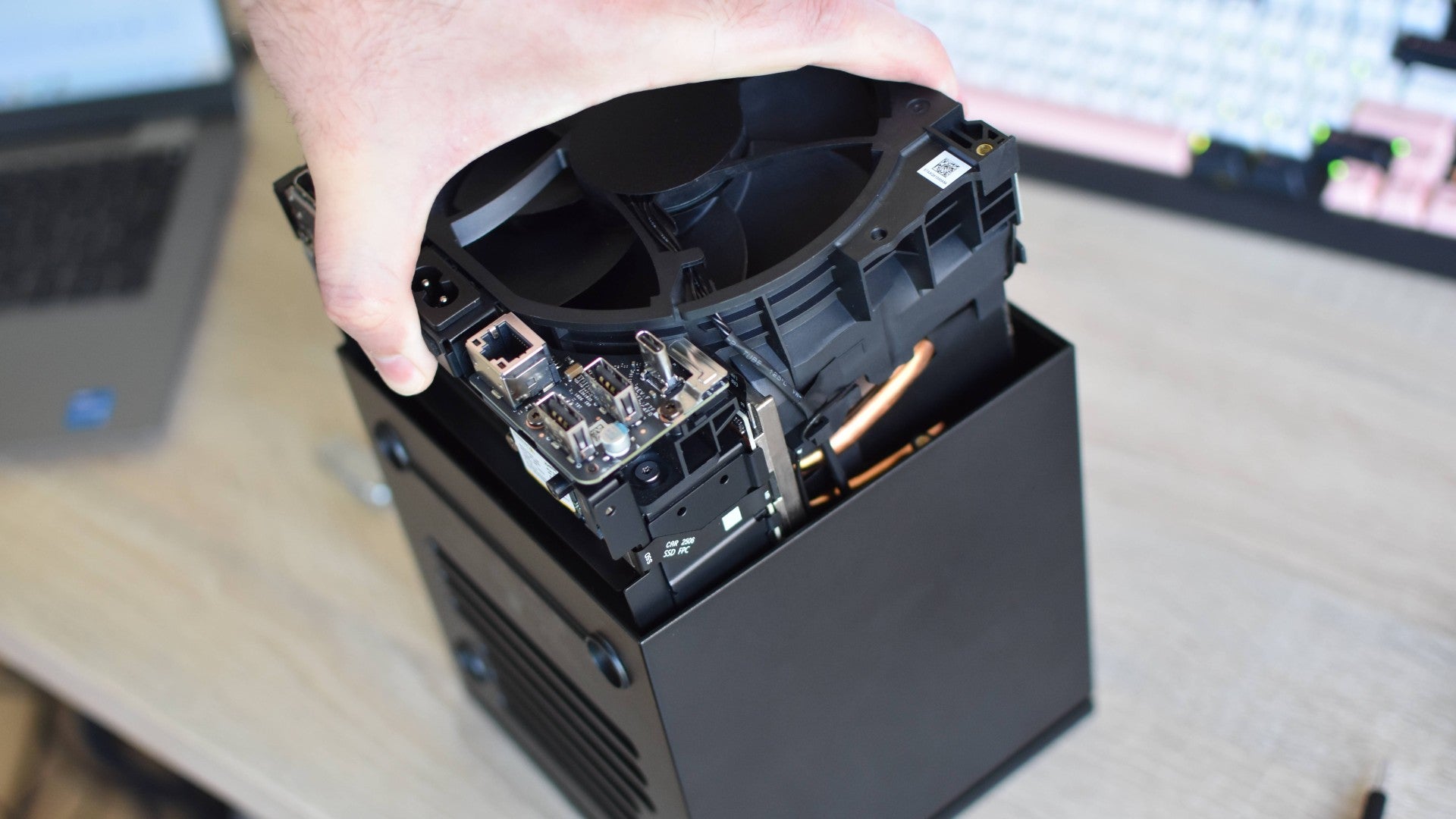 Removing a Steam Machine's internal assembly from its opened case.