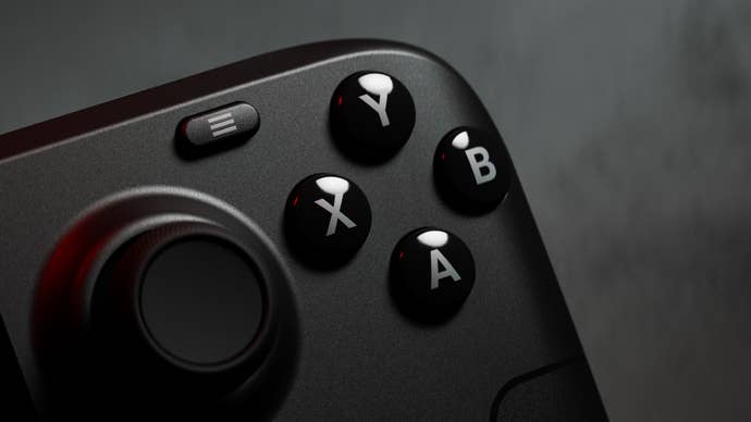 A close-up of the Steam Deck OLED, seeing the four face buttons glinting in some lovely red-ish light.