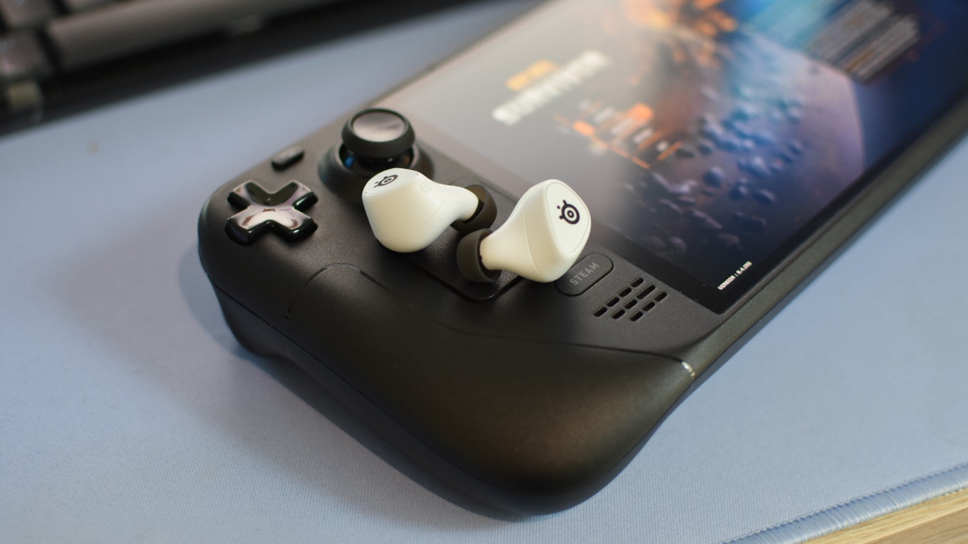 The SteelSeries Arctis GameBuds sat on top of a Steam Deck OLED. - 7