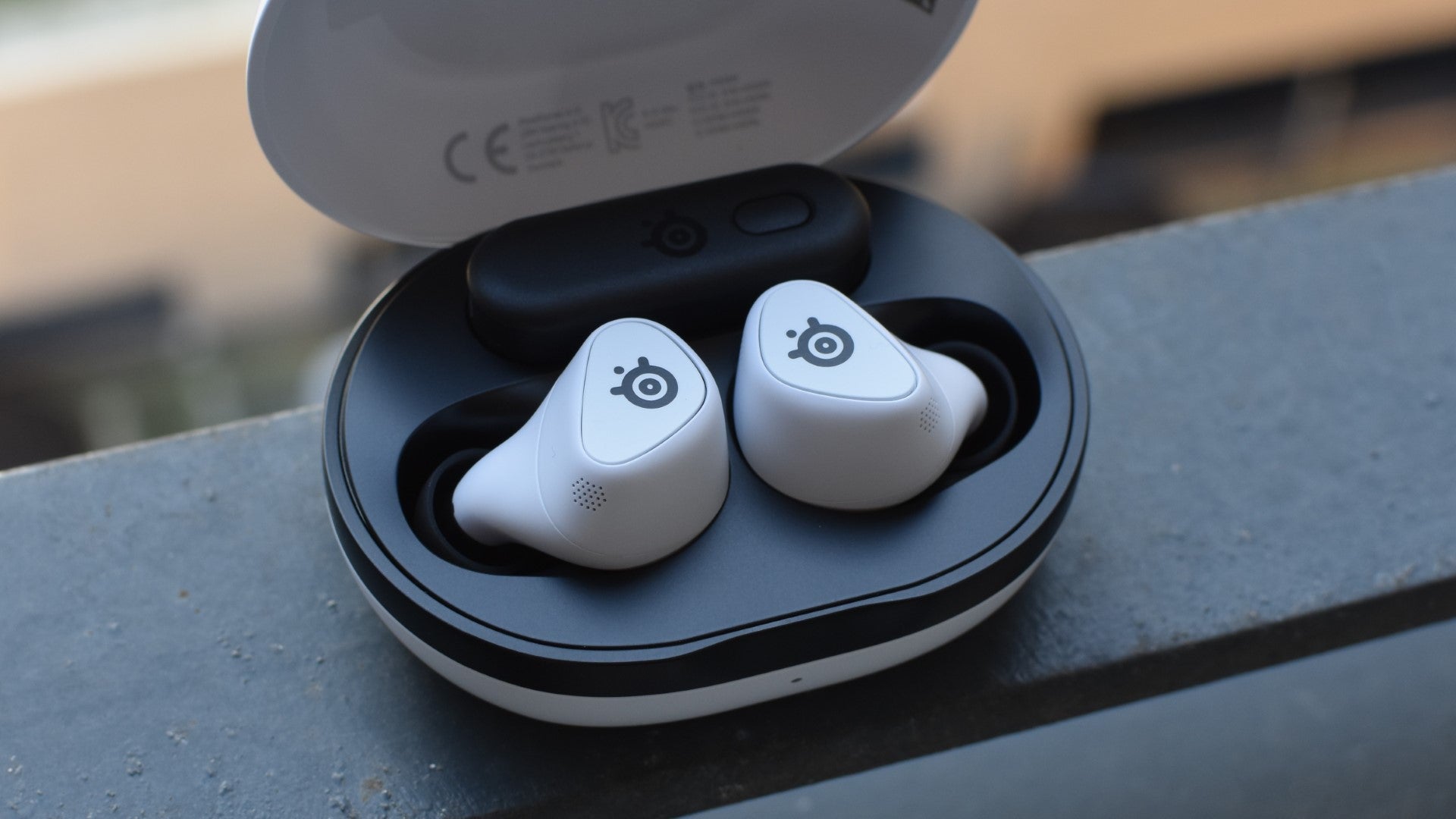 The SteelSeries Arctis GameBuds gaming earbuds in their charging case. - 1