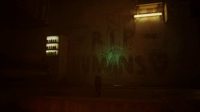 Stray screenshot showing a Vending machine lit up next to some graffiti that reads “RIP Humans” in a very dark alleyway.