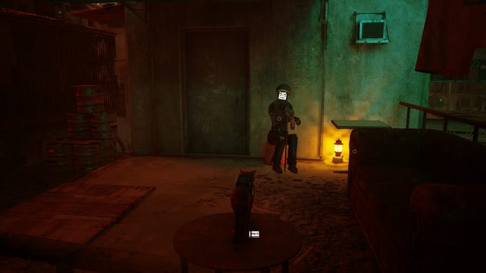 Stray screenshot showing a cat staring at a robot sat on a bucket. They are both next to a sofa on a rooftop.