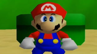 Mario stands in front of a pipe in Super Mario 64. He is wearing blue dungarees, a red top, white gloves and a red hat with the letter M on the front