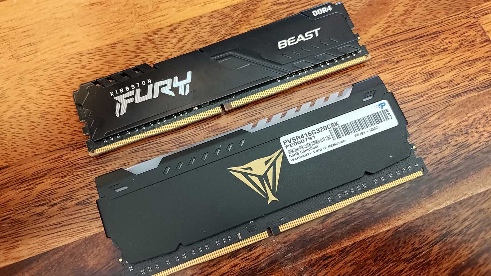 Two sticks of mismatched RAM on a table.