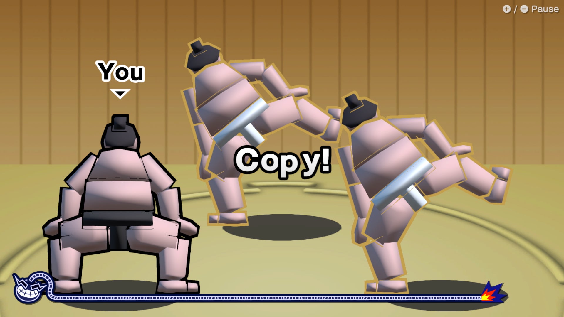 Three sumo wrestlers, seen from behind, all assume the traditional squat-legged stance. A sign over them all says 'Copy!' - 4