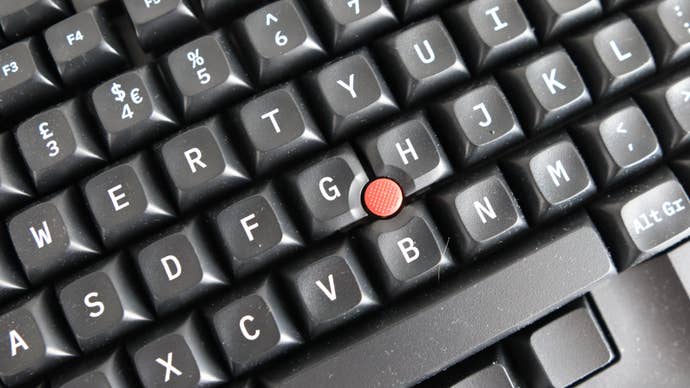 Closeup of Trackpoint on Tex Shinobi keyboard on grey background