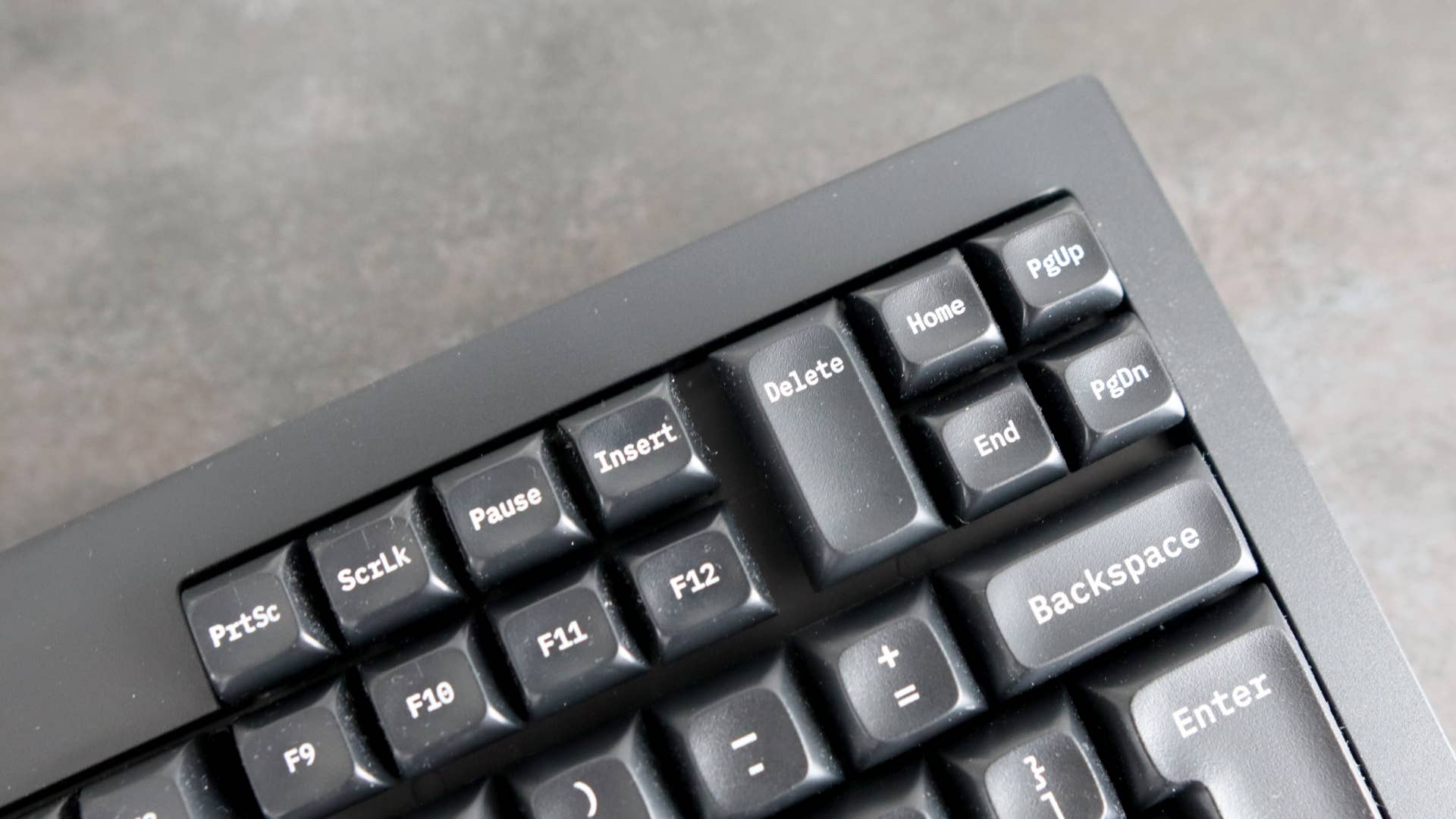 Closeup of navigation buttons on Tex Shinobi keyboard on grey background