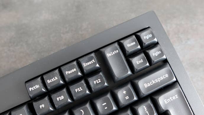 Closeup of navigation buttons on Tex Shinobi keyboard on grey background
