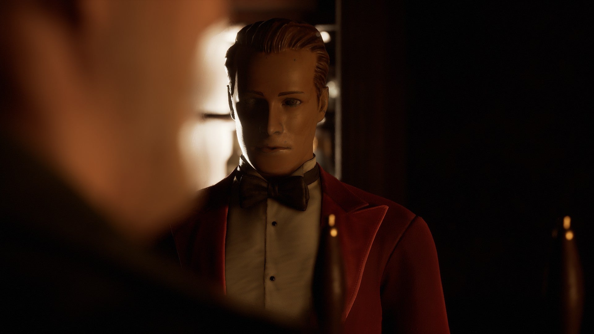 A screenshot from The Devil In Me showing a creepy bell boy staring at a character off-screen