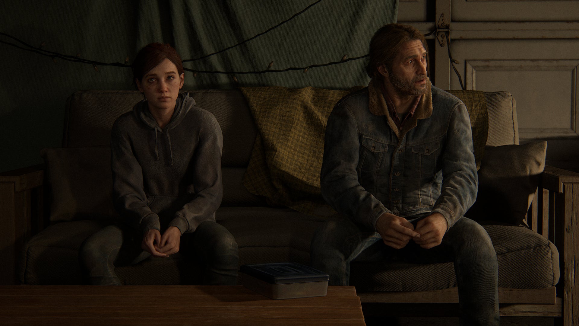 Ellie and Tommy sit awkwardly on a sofa in The Last of Us Part II Remastered. - 7