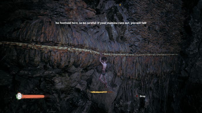 Gollum hangs from a ledge on the side of a mountain in The Lord Of The Rings: Gollum