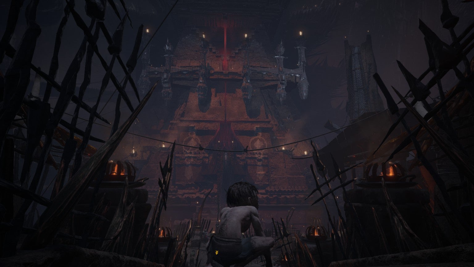 Gollum stands in front of a dark fortress in The Lord Of The Rings: Gollum