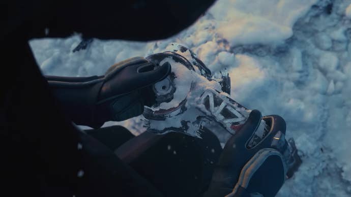 A buried N7 insignia is uncovered from the snow, in this screenshot from BioWare’s first Mass Effect 5 teaser trailer.