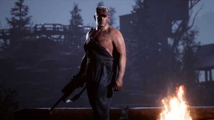 Bobby Hackett, also known as a hunter, standing menacingly over a bonfire in The Quarry.