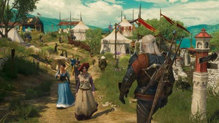 A white-haired witcher, Geralt of Rivia, can be seen walking past some women and other local folk down a path towards a camp in The Witcher's Blood and Wine DLC