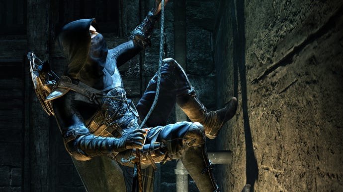 Garrett in 2014's Thief reboot, climbing a wall on a rope. He's wearing all black leather and is hooded.