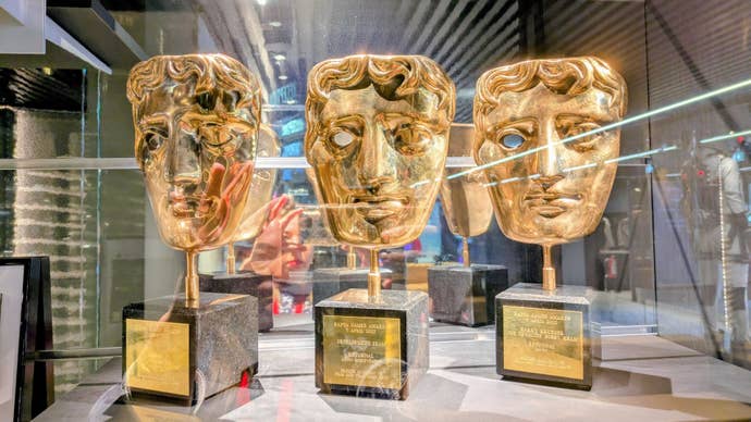 Three of Housemarque's BAFTA awards in a glass case