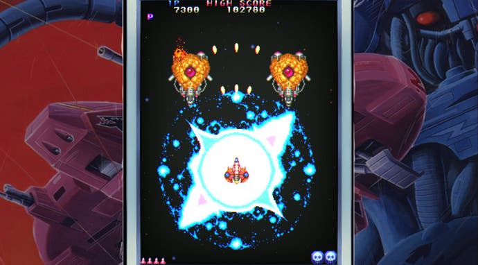 Toaplan Arcade review - Truxton in action, with a flash of wite light around you character in centre screen