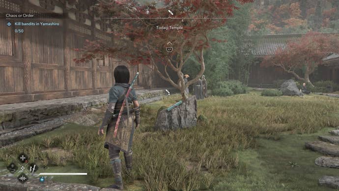 Naoe looking at a Lost Page at Todaiki Temple in Assassin’s Creed Shadows.