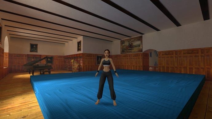 Lara stands on a giant crash mat inside her music room in the original Tomb Raider