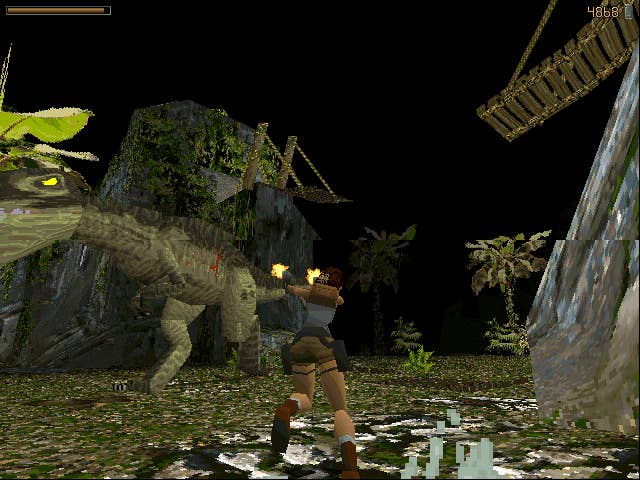 Lara Croft fires at a dinosaur in Tomb Raider