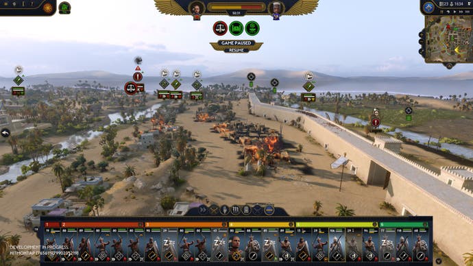 Total War Pharaoh preview - screenshot of Mennefer siege with some buildings on fire inside the walls