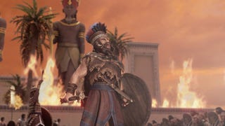 Total War Pharaoh screenshot showing the lands ablaze with fire as a soldier stands in the foreground with an expression that makes it appear he is letting out some kind of battle cry.