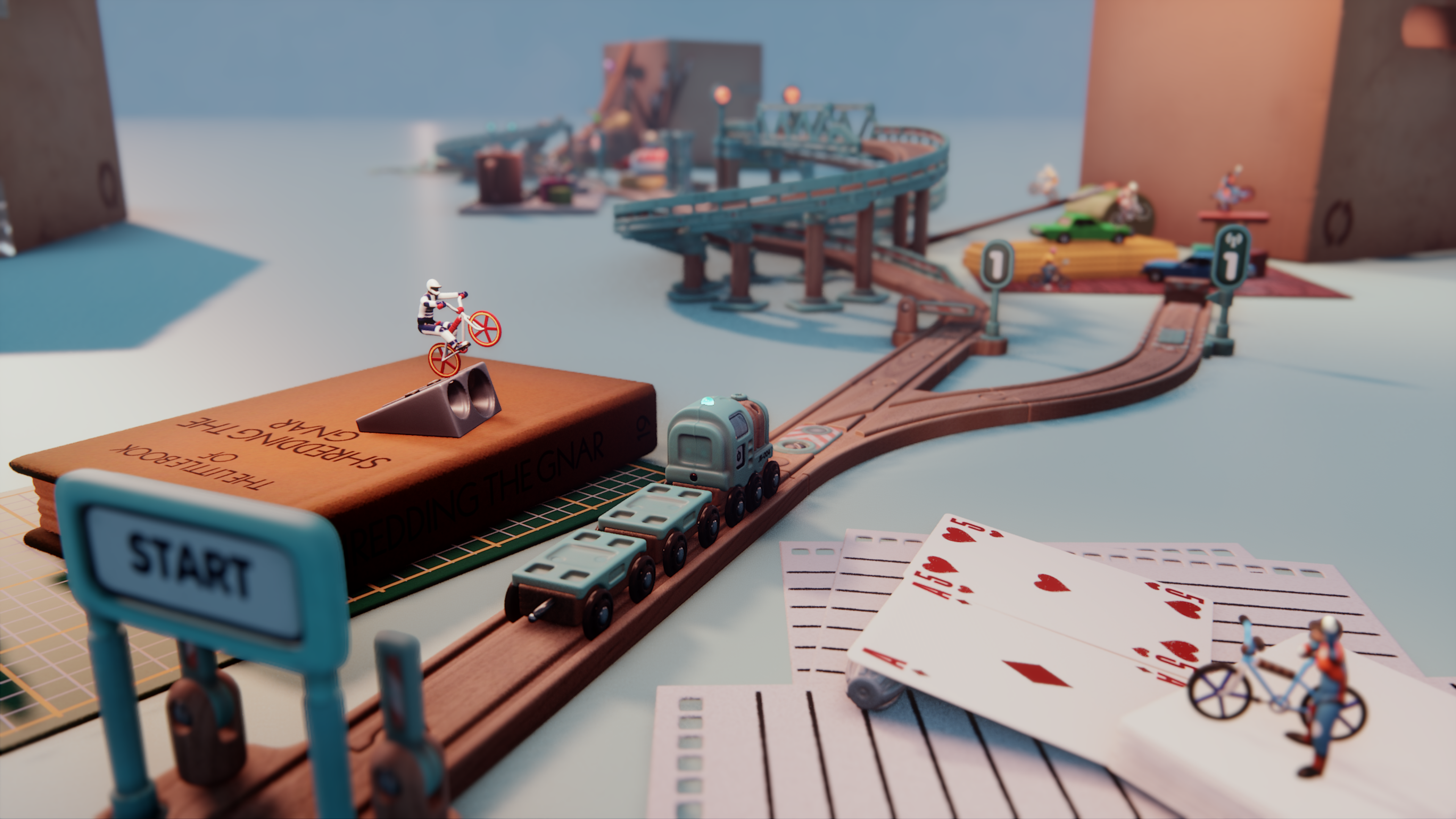 A small toy train track goes off into the distance, and around it, a variety of small figures stage a little bike stunt off playing cards and stacked books.