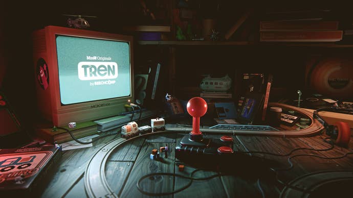 How your Tren journey begins; a small toy train sits in front of retro arcade stick and monitor displaying the Tren logo.