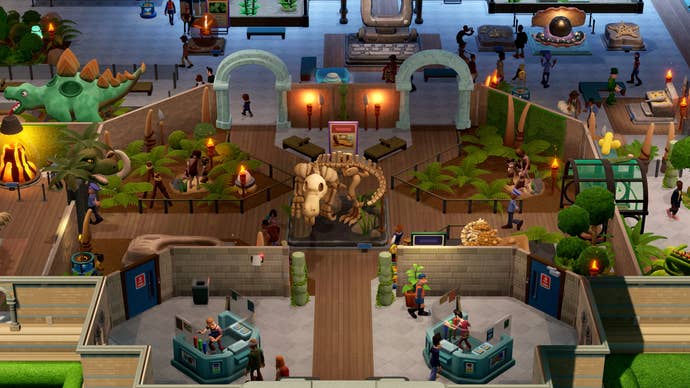 An overhead view of the Prehistory Museum in Two Point Museum is shown, showing off multiple fossils as well as the museum entrance and ticket kiosks