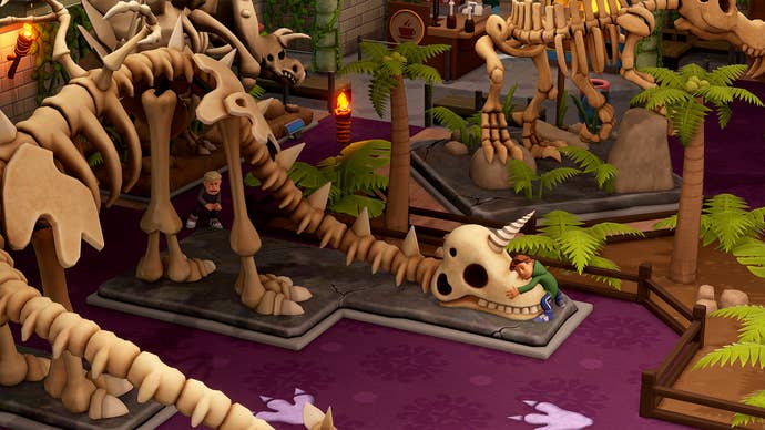 A schoolkid hugs a dinosaur skeleton in Two Point Museum.