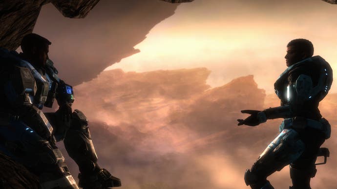Two Spartans chat in front of a rugged backdrop of dawn mountains in Halo: Reach.