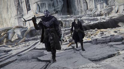 Two characters in Elden Ring Nightreign walking towards the camera through a large white stoned courtyard like area