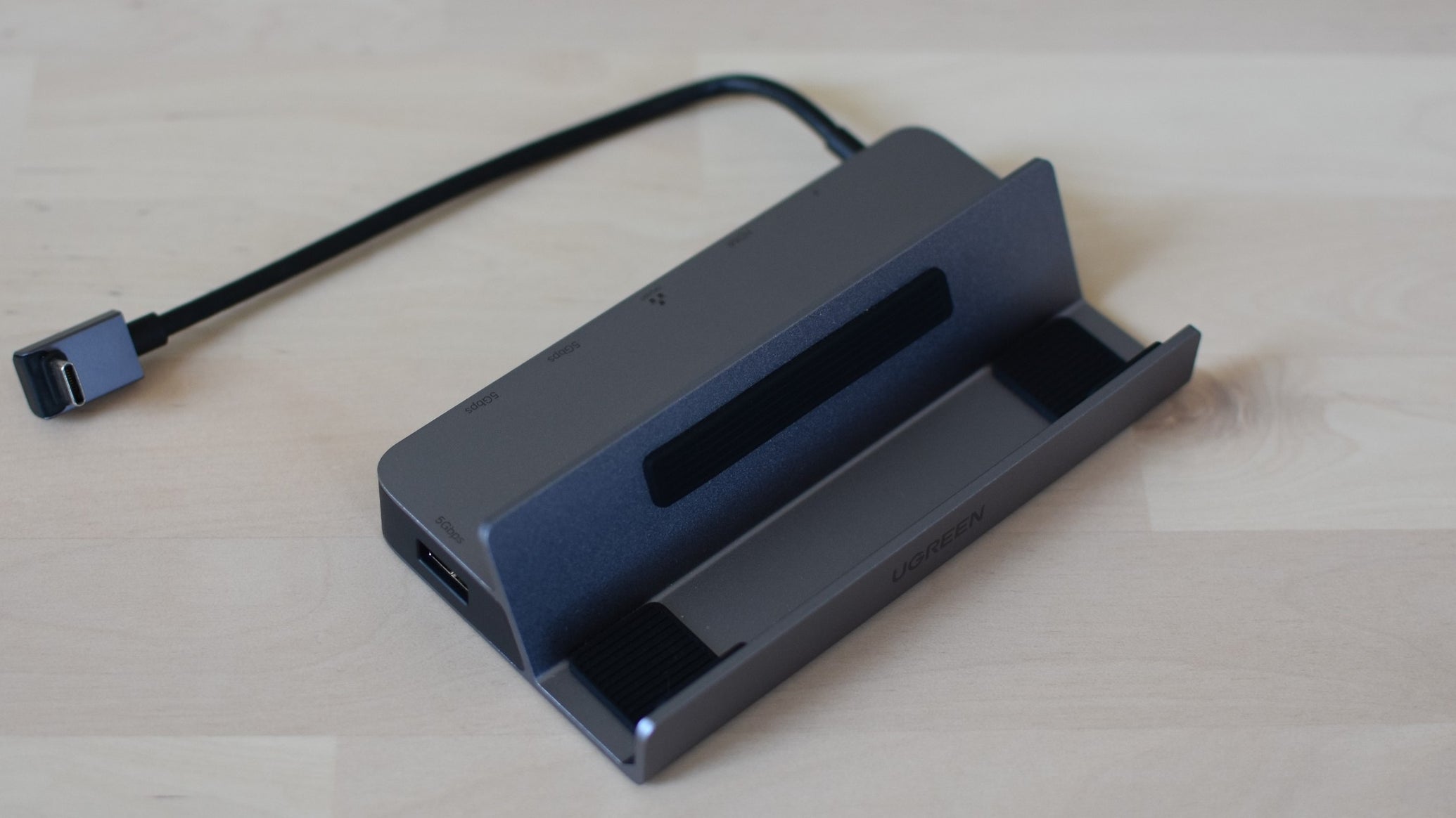 The Ugreen Steam Deck Docking Station on a desk. - 1