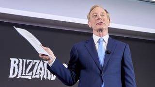 Microsoft's Brad Smith holds up his unsigned PlayStation contract.