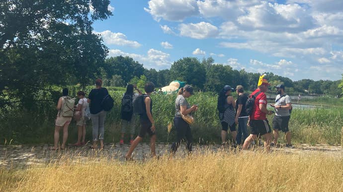 Players walk past an inflatable Snorlax at Pokémon Go Fest 2022.