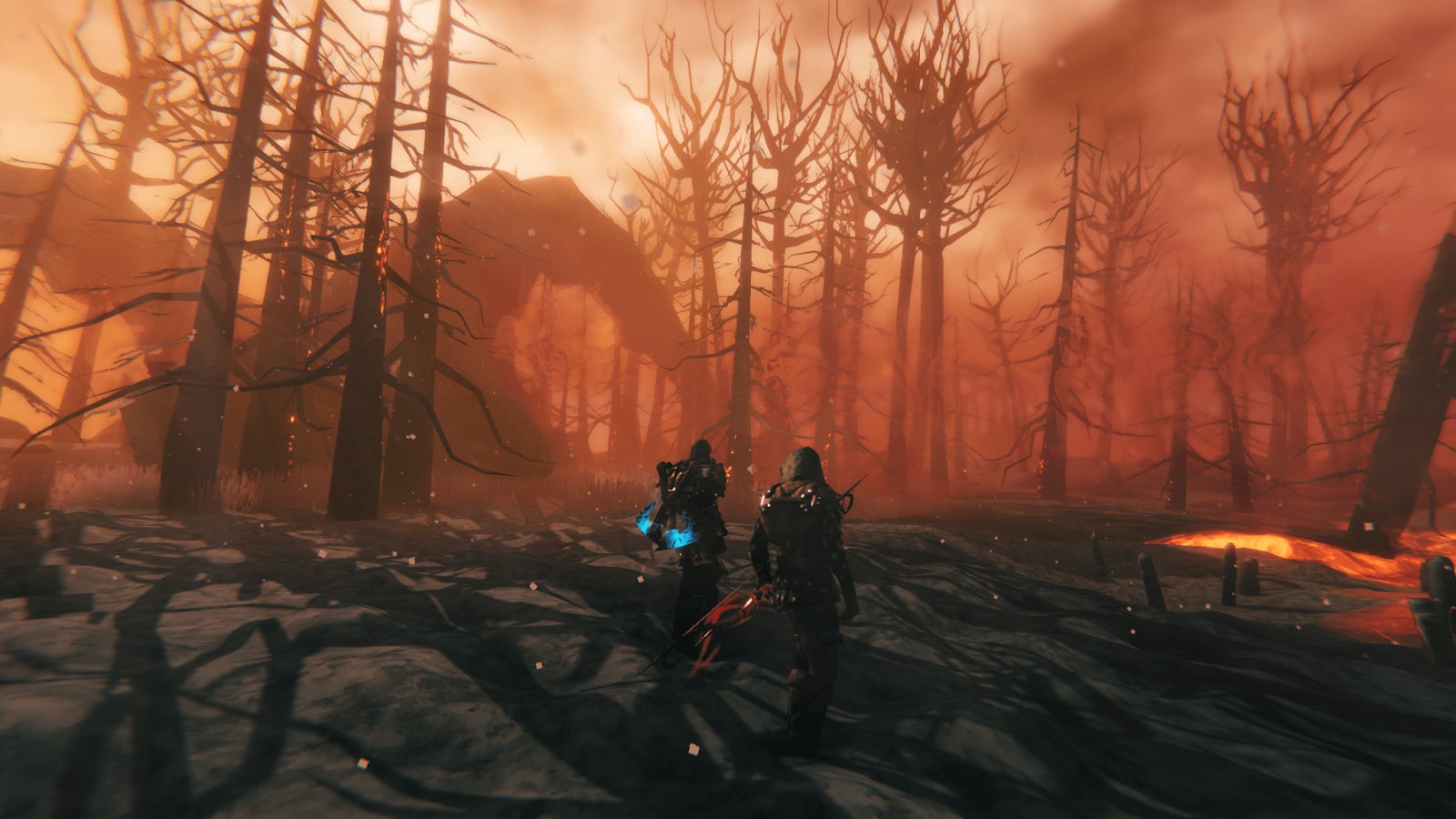 Players wander a volcanic landscape in Valheim - 1
