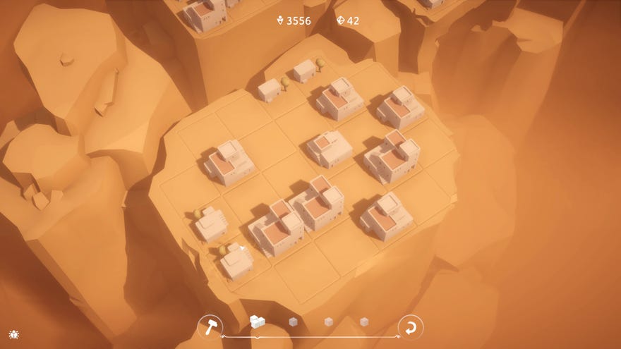 A village of desert-themed houses perch on top of a small rocky tower in Urbo