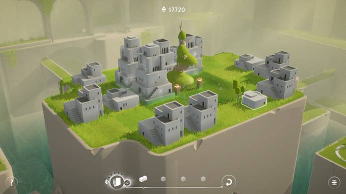 A grassy town is perched on a white cliff face in Urbo