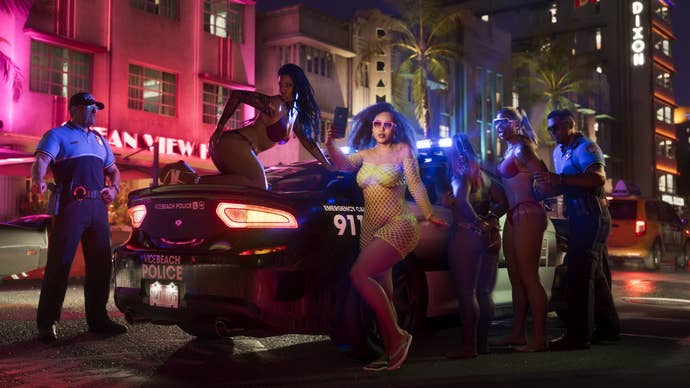 GTA 6 screenshot showing girls posing on a cop car for selfies while being arrested